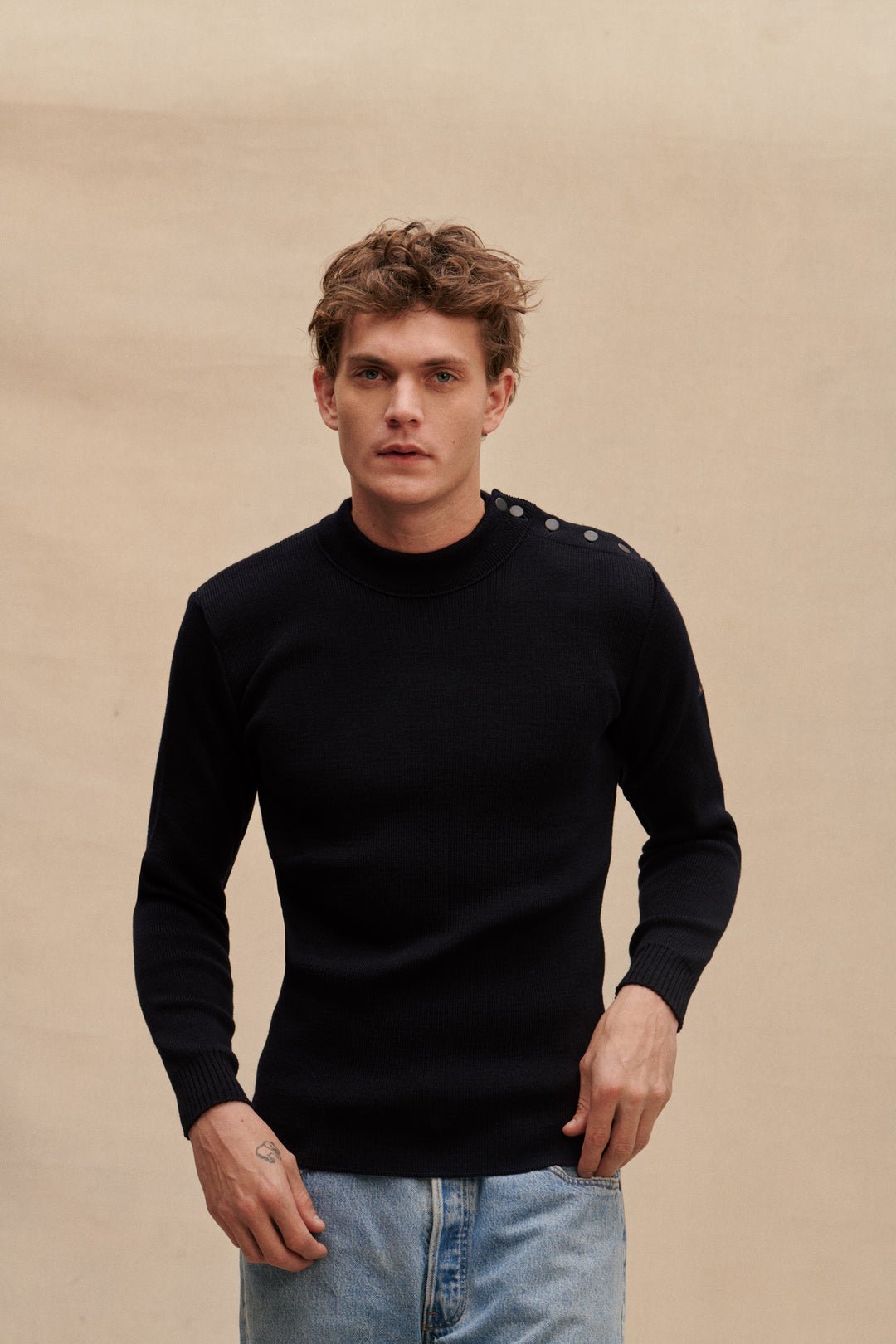 Homme portant un pull marin bleu Le Minor boutonné à l’épaule