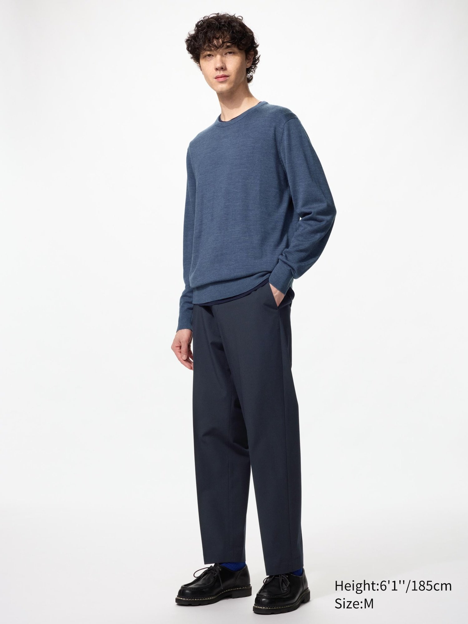 Homme portant un pull bleu en mérinos Uniqlo